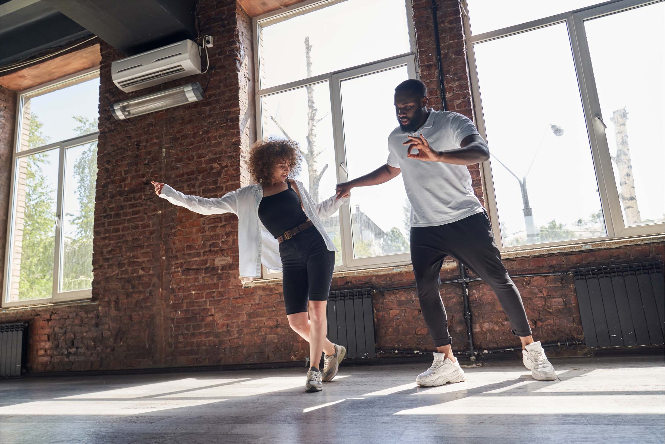 Two adults learning a dance.