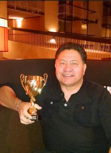 Richard Martinez holding a trophy.